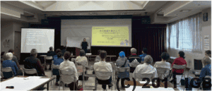 甲府市聴覚障害者協会主催の防災講演会にてNPO法人インフォメーションギャップバスター　インクルーシブ防災プロジェクトの鈴木義雅が講演している会場の様子